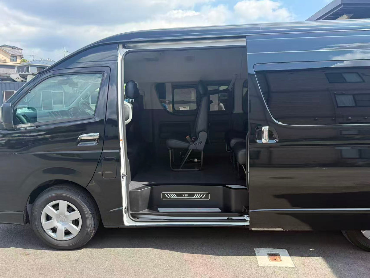 Black Toyota HiAce passenger van with open sliding door