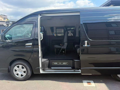 Black Toyota HiAce passenger van with open sliding door