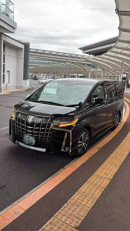 Black Toyota Alphard private tour vehicle parked at a pickup point