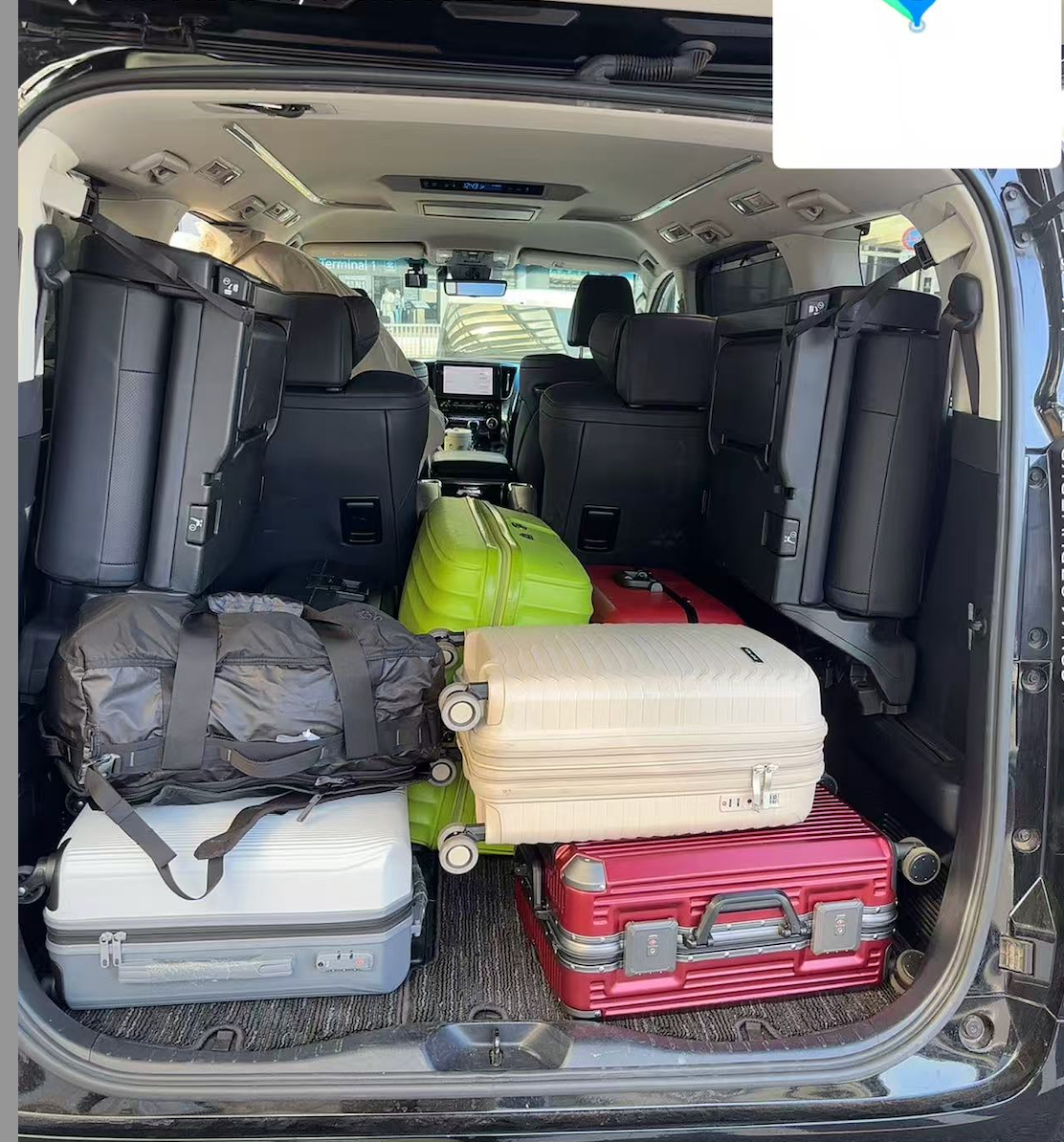 Private driver loading luggage into a Toyota Alphard in Japan